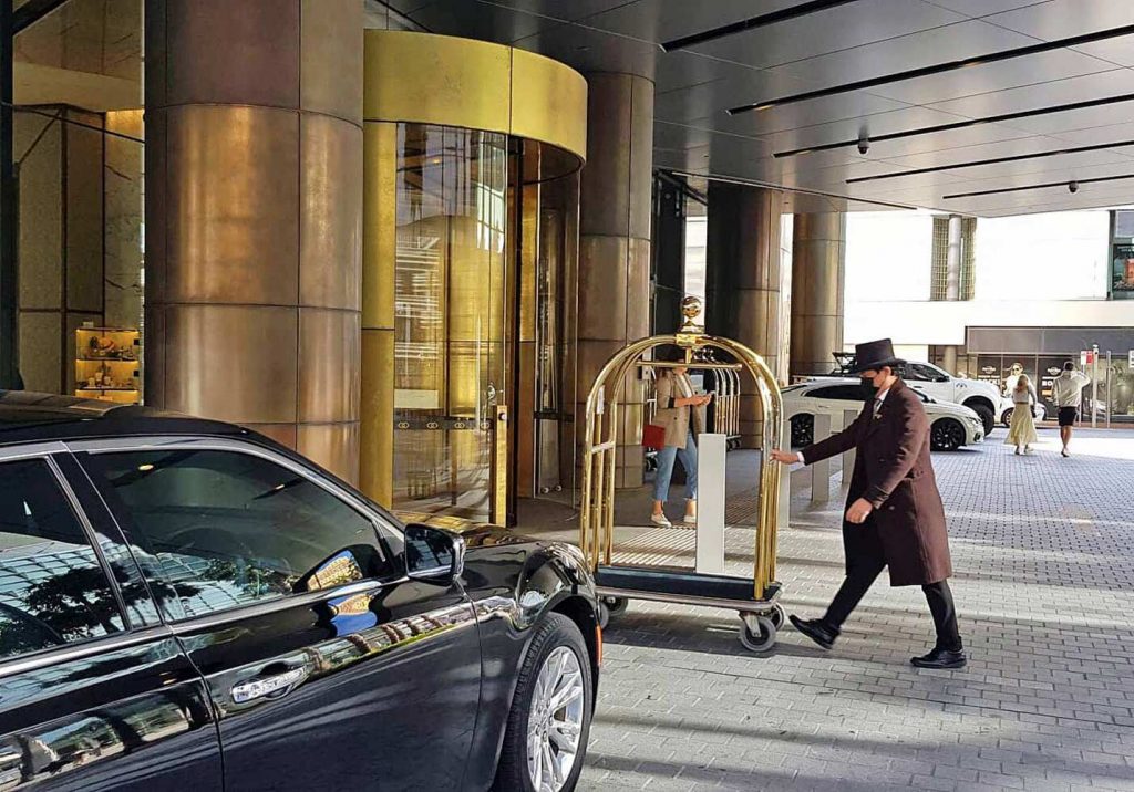 Black Car in front of hotel entrance